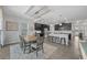 Inviting dining area adjacent to a modern kitchen with dark cabinets and an island with barstool seating at 12048 Imaginary Way, Orlando, FL 32832