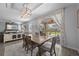 Cozy dining area with a view of the backyard through sliding glass doors, complemented by a comfortable living space at 12048 Imaginary Way, Orlando, FL 32832