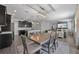 Open-concept living space with a dining area, kitchen featuring dark cabinetry, and living room with a fireplace at 12048 Imaginary Way, Orlando, FL 32832