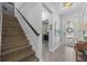 Bright entryway with wood floors, staircase, decorative art, and a view into the adjacent office space at 12048 Imaginary Way, Orlando, FL 32832