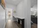 Hallway with a built-in desk area, leading to a patio and a glimpse of the living room at 12048 Imaginary Way, Orlando, FL 32832