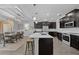 Open kitchen featuring a large island with seating and stainless steel appliances, adjacent to a dining area at 12048 Imaginary Way, Orlando, FL 32832