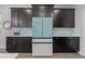 Close-up of a modern refrigerator surrounded by dark cabinets and light blue backsplash tiles at 12048 Imaginary Way, Orlando, FL 32832