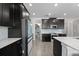 Well-equipped kitchen with dark cabinets, white countertops, and a view into a pantry at 12048 Imaginary Way, Orlando, FL 32832
