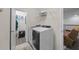 Functional laundry room with modern washer and dryer, ample storage space, and convenient access to other areas at 12048 Imaginary Way, Orlando, FL 32832