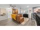 Inviting living room featuring a wood-accent wall, guitars, modern furniture, and a stylish entertainment area at 12048 Imaginary Way, Orlando, FL 32832