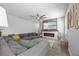 Cozy living room with a large sectional sofa, electric fireplace, and mounted television at 12048 Imaginary Way, Orlando, FL 32832