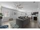 Bright living room with a large sectional sofa, ceiling fan, and view into the kitchen at 12048 Imaginary Way, Orlando, FL 32832