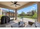 Screened patio featuring pavers, ceiling fan, and outdoor seating overlooking the backyard at 12048 Imaginary Way, Orlando, FL 32832
