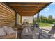 Backyard pergola with comfortable seating, a fire pit, and privacy screen at 12048 Imaginary Way, Orlando, FL 32832