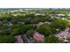 Community aerial showcasing lush trees and landscaping surrounding residential homes at 1270 Saint Tropez Cir # Ge, Orlando, FL 32806
