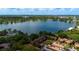 Aerial view showcasing the community's lakefront location, surrounded by mature trees and beautiful scenery at 1270 Saint Tropez Cir # Ge, Orlando, FL 32806