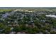 Aerial view showcasing the community nestled amongst lush trees, a lake and surrounding residential homes at 1270 Saint Tropez Cir # Ge, Orlando, FL 32806