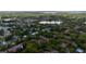 Aerial view showcasing the community nestled amongst lush trees, a lake, and surrounding residential homes at 1270 Saint Tropez Cir # Ge, Orlando, FL 32806
