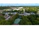 Aerial view of community with tennis court, pond with fountain, and downtown in background at 1270 Saint Tropez Cir # Ge, Orlando, FL 32806
