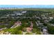 Community aerial showcasing lush trees, a tennis court, a community pool and surrounding residential homes at 1270 Saint Tropez Cir # Ge, Orlando, FL 32806