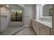 A stylish bathroom features a glass shower, a vanity with white cabinets, and modern fixtures at 1270 Saint Tropez Cir # Ge, Orlando, FL 32806