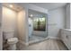 An updated bathroom featuring a glass shower, a window, and a vanity with storage at 1270 Saint Tropez Cir # Ge, Orlando, FL 32806