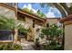 Exterior of the condo with brick and tropical landscaping leading to the front door at 1270 Saint Tropez Cir # Ge, Orlando, FL 32806