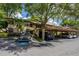 Beige condo with a carport and ample parking spaces covered by mature shade trees at 1270 Saint Tropez Cir # Ge, Orlando, FL 32806
