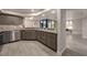 Renovated kitchen with gray cabinets, granite counters and stainless appliances next to the open living area at 1270 Saint Tropez Cir # Ge, Orlando, FL 32806