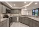 Stylish kitchen with gray cabinetry, stainless steel appliances, and modern countertops and backsplash at 1270 Saint Tropez Cir # Ge, Orlando, FL 32806