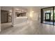 Open-concept living room and kitchen with wood-look tile and stainless steel appliances at 1270 Saint Tropez Cir # Ge, Orlando, FL 32806
