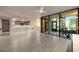 Bright living room featuring tile flooring, modern fixtures, and an open layout with access to the kitchen at 1270 Saint Tropez Cir # Ge, Orlando, FL 32806