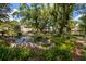 Serene pond with fountain feature surrounded by lush landscaping near mediterranean style buildings at 1270 Saint Tropez Cir # Ge, Orlando, FL 32806