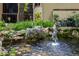 Water fountain feature in a pond with a duck swimming in it near mediterranean style buildings at 1270 Saint Tropez Cir # Ge, Orlando, FL 32806
