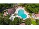 Aerial view of uniquely shaped community pool with hot tub, pergola, and lush landscaping at 1270 Saint Tropez Cir # Ge, Orlando, FL 32806