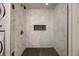 A modern shower features white marbled tile, a built-in niche, and sleek fixtures for a spa-like experience at 1270 Saint Tropez Cir # Ge, Orlando, FL 32806