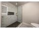 A glass-enclosed shower features marble-look tile, a dark tile floor, and a built-in niche at 1270 Saint Tropez Cir # Ge, Orlando, FL 32806