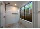 Modern shower with a large window, gray tiling and a built-in shelf at 1270 Saint Tropez Cir # Ge, Orlando, FL 32806