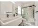Stylish bathroom with dual sinks and luxurious walk-in shower with marble tile at 13208 Canna Lily Dr, Orlando, FL 32824