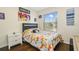 bedroom with window, dinosaur bedding and decor at 13208 Canna Lily Dr, Orlando, FL 32824