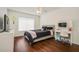 Bedroom with modern decor, including laminate wood floors, a TV, and white furniture at 13208 Canna Lily Dr, Orlando, FL 32824