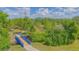 Scenic blue bridge over a stream, surrounded by lush greenery and leading to a tranquil lake at 13208 Canna Lily Dr, Orlando, FL 32824