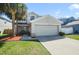 Charming two-story home with a two car garage and a well-manicured front yard with beautiful landscaping at 13208 Canna Lily Dr, Orlando, FL 32824