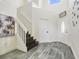 Bright foyer featuring tile flooring and a staircase, creating a grand entrance with lots of natural light at 13208 Canna Lily Dr, Orlando, FL 32824
