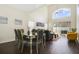 Spacious living room with high ceilings, an oversized window, and comfortable seating. Natural light and airy at 13208 Canna Lily Dr, Orlando, FL 32824