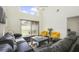 Large living room with ample seating, a modern rug, and a sliding glass door, open and airy space at 13208 Canna Lily Dr, Orlando, FL 32824