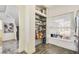 Pantry with tiled floors and organized shelving next to window at 13208 Canna Lily Dr, Orlando, FL 32824