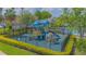 Community playground featuring slides, climbing wall, and swings, surrounded by a secure black fence at 13208 Canna Lily Dr, Orlando, FL 32824