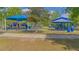 Community playground with covered picnic tables, slides, and play equipment, perfect for Gathering fun at 13208 Canna Lily Dr, Orlando, FL 32824