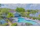 Community pool with lounge chairs, a seating area, and picturesque lake views at 13208 Canna Lily Dr, Orlando, FL 32824