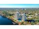 Aerial view of two highrise condominium buildings on the lake, with pool, private dock and lush landscaping at 13427 Blue Heron Beach Dr # 1205, Orlando, FL 32821