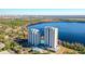 Scenic aerial shot showcases condo buildings overlooking a tranquil lake and landscaped grounds at 13427 Blue Heron Beach Dr # 1205, Orlando, FL 32821
