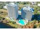 Aerial view of buildings, pool, lake, trees and surrounding area at 13427 Blue Heron Beach Dr # 1205, Orlando, FL 32821