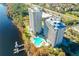 Aerial view of buildings, pool, lake, trees and surrounding area on a sunny day at 13427 Blue Heron Beach Dr # 1205, Orlando, FL 32821